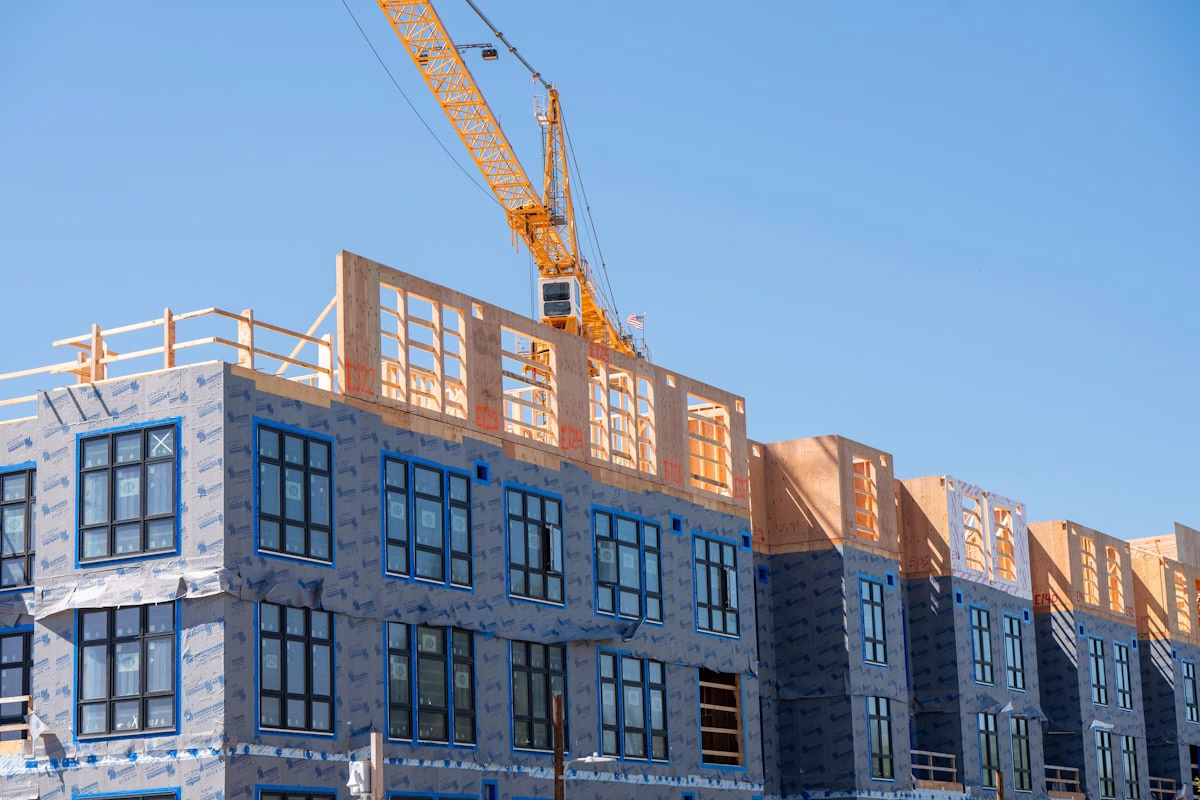 Obra de predio residencial em construcao, com estrutura de concreto aparente e andaimes.